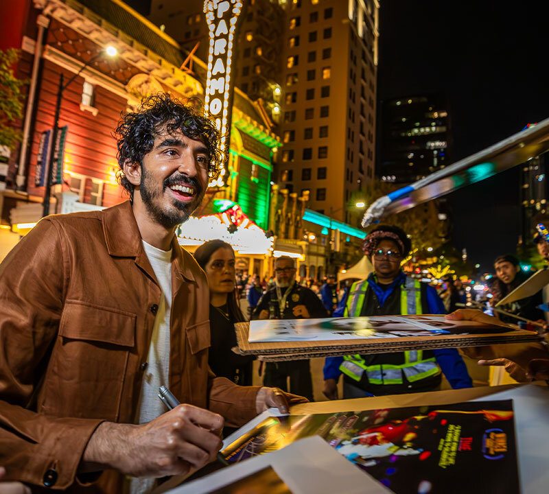 Dev Patel signs autographs before the World Premiere of Monkey Man at SXSW 2024 - Photo by Aaron Rogosin